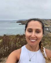 [Photo of Brittney O'Brien with the coast in the background]